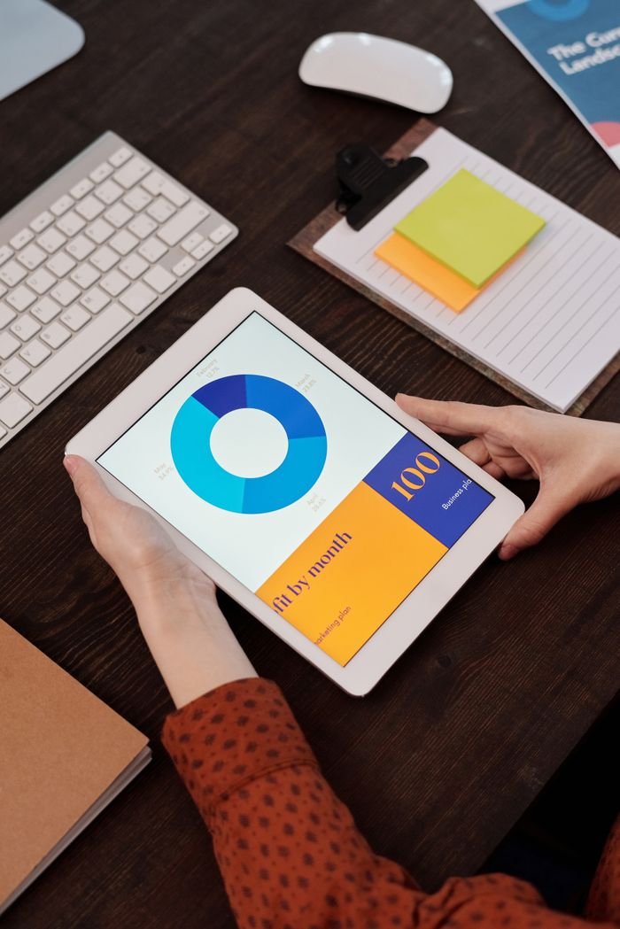 About Modern office setting featuring a digital tablet displaying a graph, perfect for business presentations.