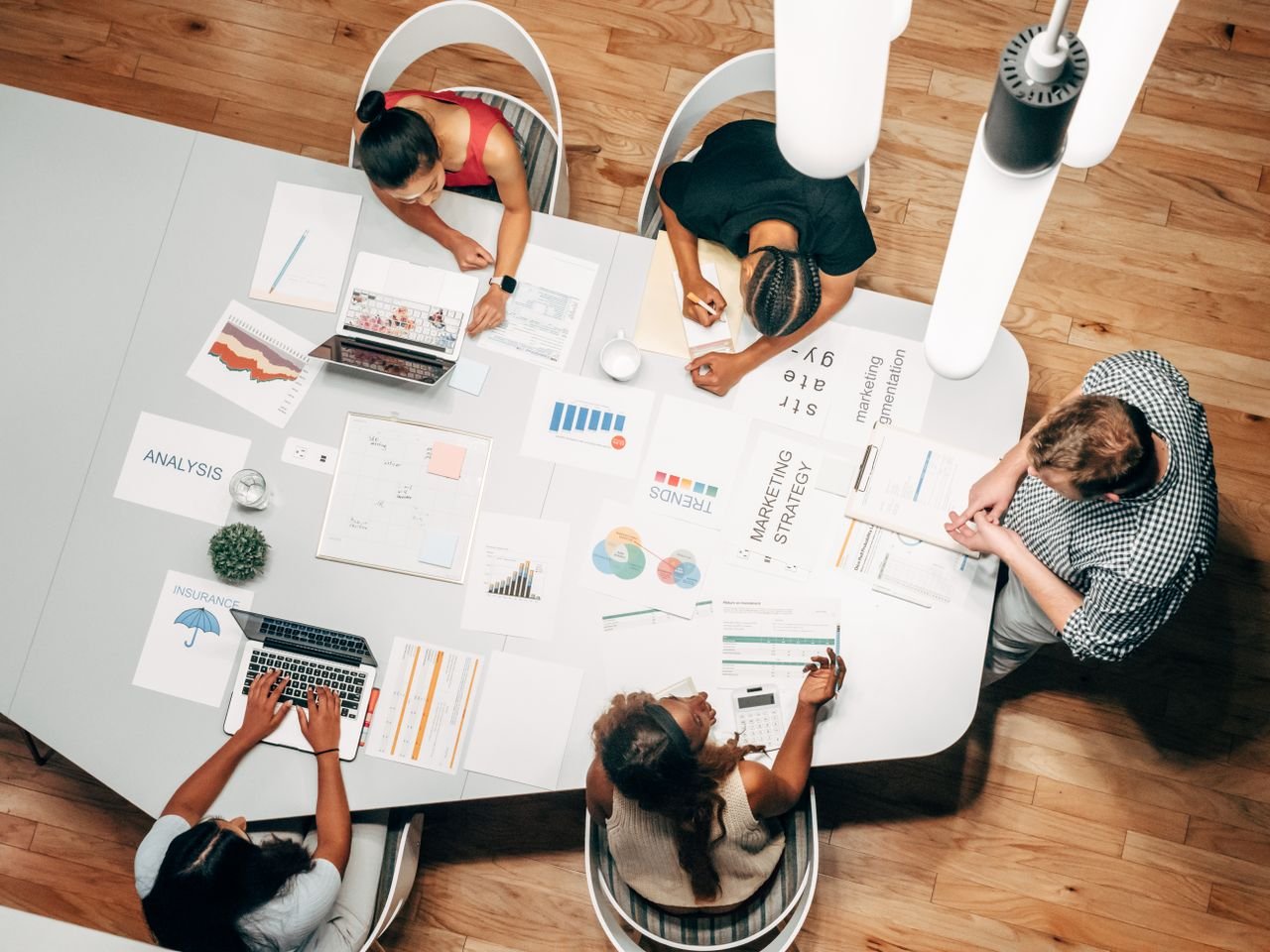 Services Diverse team collaborating on marketing strategy in a modern office setting.